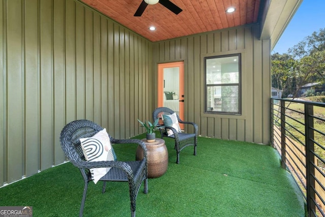 view of patio with ceiling fan and a balcony