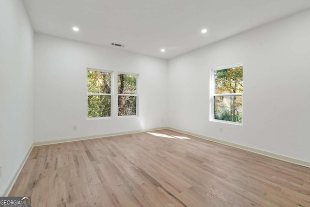 unfurnished room with light hardwood / wood-style flooring