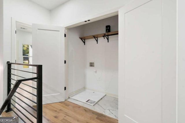 interior space featuring washer hookup and hardwood / wood-style floors