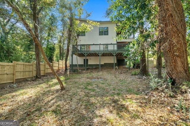 rear view of property with a wooden deck