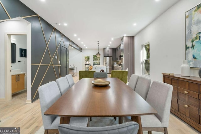 dining room featuring a wealth of natural light and light hardwood / wood-style flooring