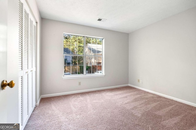 unfurnished bedroom featuring carpet floors and a textured ceiling