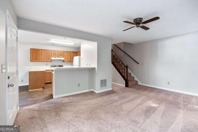 unfurnished living room with carpet floors and ceiling fan