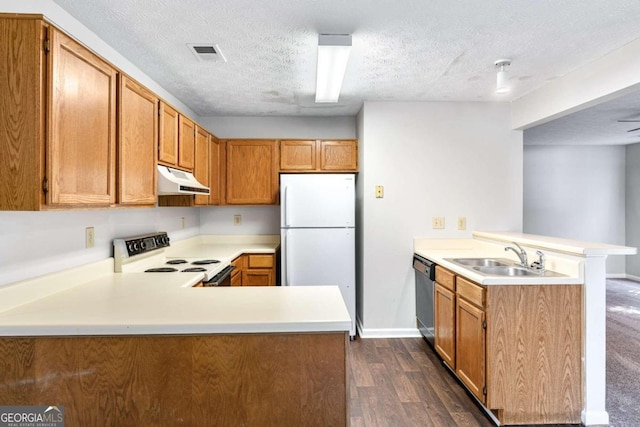 kitchen with dark wood-type flooring, kitchen peninsula, a textured ceiling, and white appliances