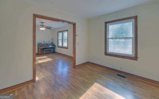 unfurnished room with ceiling fan and dark hardwood / wood-style floors