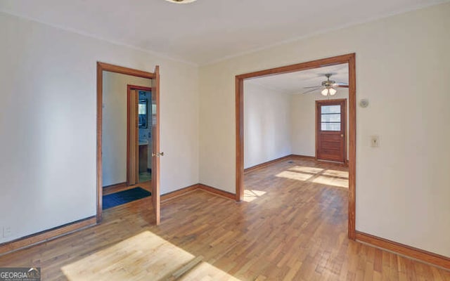 spare room with hardwood / wood-style floors and ceiling fan