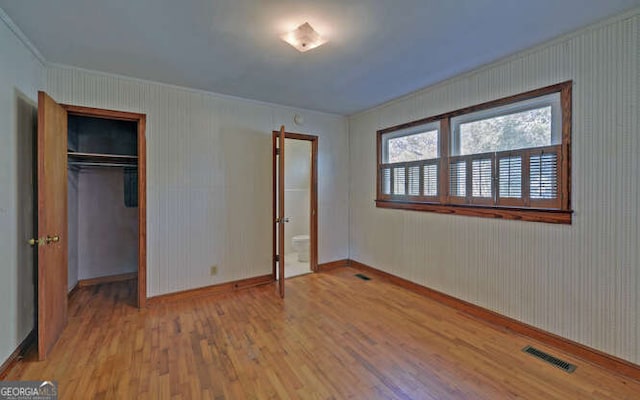 unfurnished bedroom with a closet and wood-type flooring