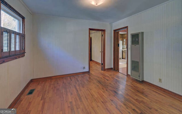 unfurnished room featuring wooden walls and dark hardwood / wood-style flooring