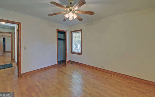 unfurnished bedroom featuring ceiling fan, a closet, and light wood-type flooring