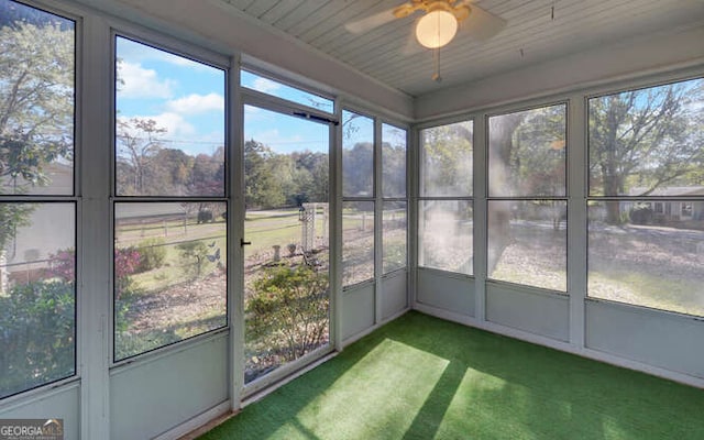 unfurnished sunroom with ceiling fan and plenty of natural light