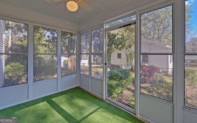 unfurnished sunroom featuring ceiling fan