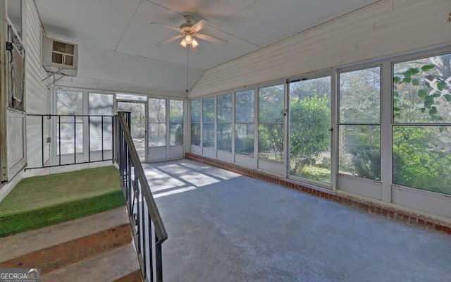 unfurnished sunroom featuring ceiling fan and vaulted ceiling