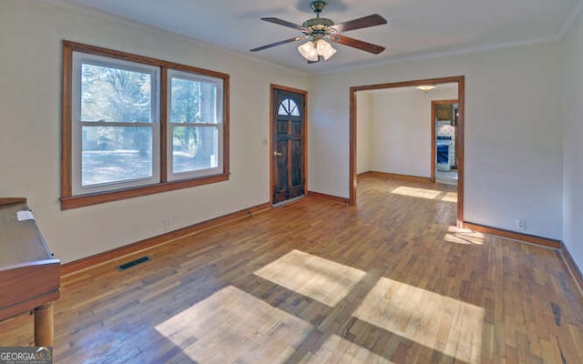 interior space featuring ceiling fan, dark hardwood / wood-style flooring, and ornamental molding