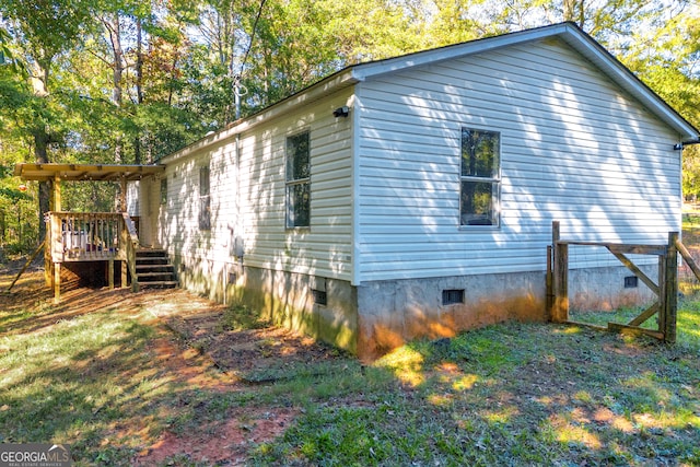 view of side of home featuring a wooden deck