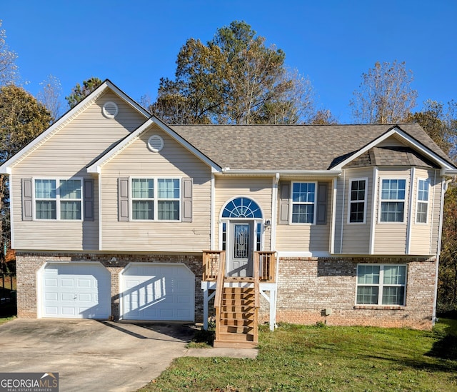 split foyer home featuring a front yard and a garage