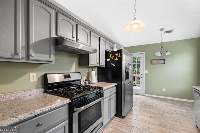 kitchen featuring gray cabinetry, under cabinet range hood, stainless steel appliances, baseboards, and hanging light fixtures