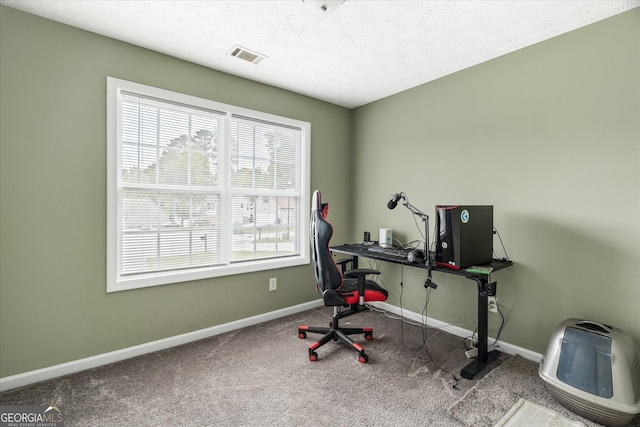 home office with baseboards, visible vents, a textured ceiling, and carpet flooring