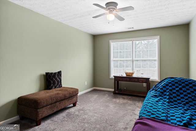 carpeted bedroom with a textured ceiling, visible vents, and baseboards