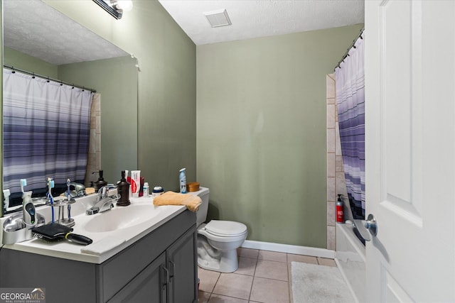 bathroom with visible vents, toilet, vanity, a textured ceiling, and tile patterned flooring