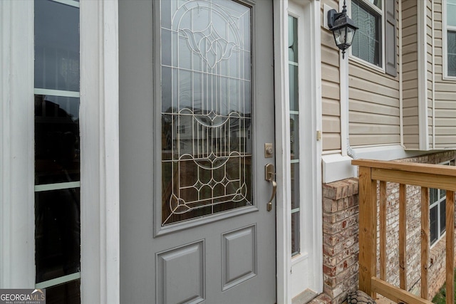 view of exterior entry with brick siding