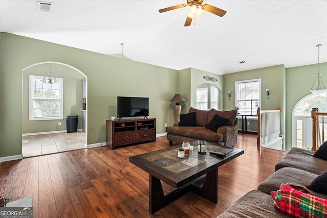 living room with visible vents, a chandelier, and hardwood / wood-style floors