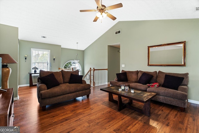 living room with lofted ceiling, baseboards, visible vents, and hardwood / wood-style floors