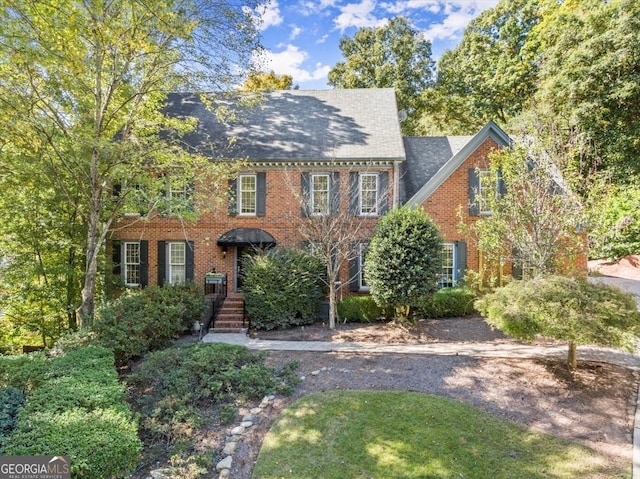 colonial home with brick siding