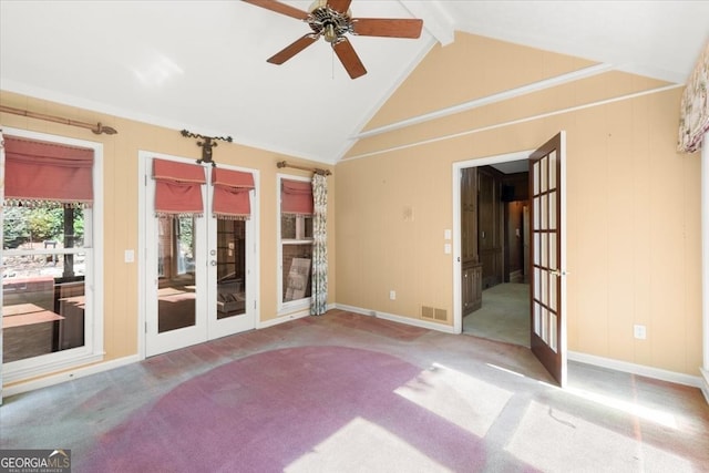 empty room with carpet floors, french doors, visible vents, and vaulted ceiling with beams