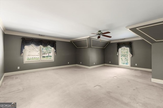 additional living space featuring light carpet, baseboards, a ceiling fan, and lofted ceiling