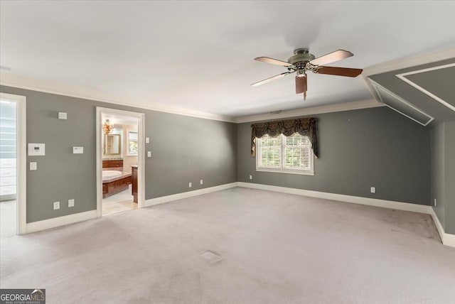 unfurnished bedroom with light carpet, ornamental molding, connected bathroom, and baseboards