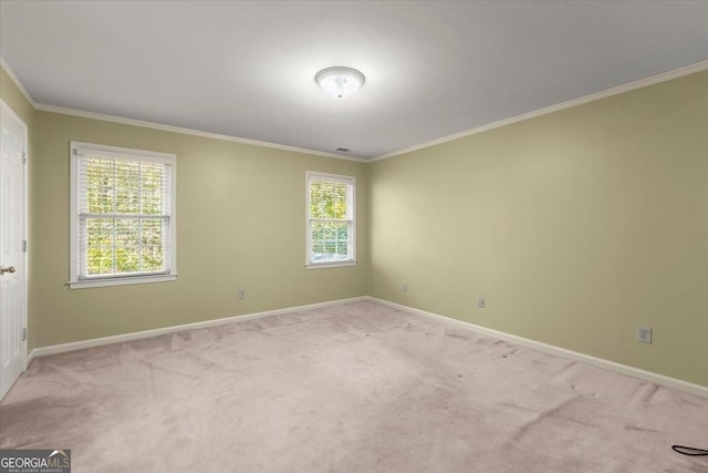 unfurnished room featuring light carpet, baseboards, and crown molding