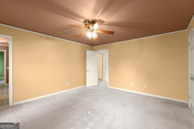 unfurnished bedroom featuring baseboards, carpet, and crown molding