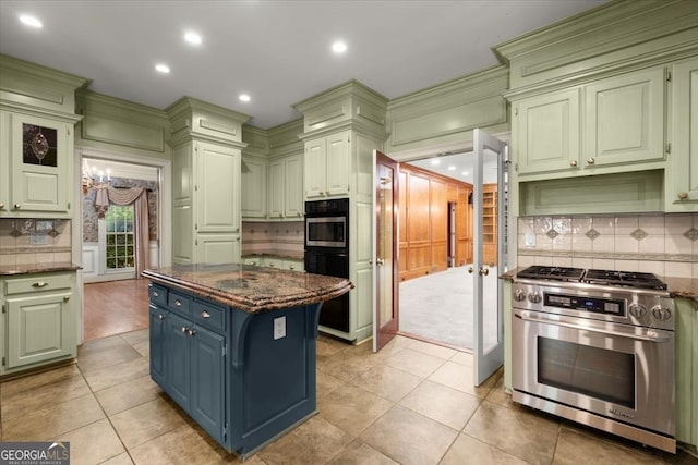 kitchen featuring light tile patterned floors, wall oven, backsplash, a center island, and gas range