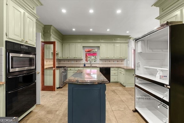 kitchen with light tile patterned floors, black dishwasher, decorative backsplash, a kitchen island, and a sink