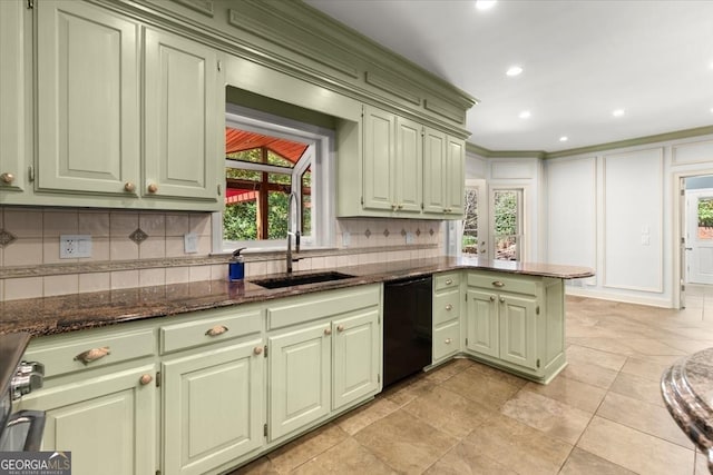 kitchen with black dishwasher, green cabinetry, a sink, and a peninsula