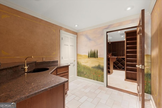 wine room featuring recessed lighting, a sink, and crown molding