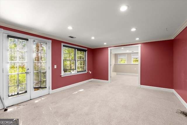 unfurnished room with visible vents, light colored carpet, and ornamental molding