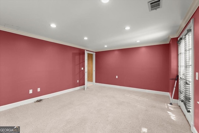 spare room featuring baseboards, visible vents, crown molding, and carpet flooring