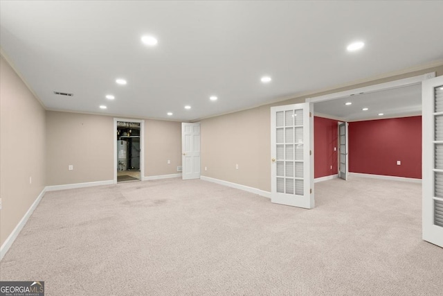 finished basement with light carpet, french doors, baseboards, and recessed lighting