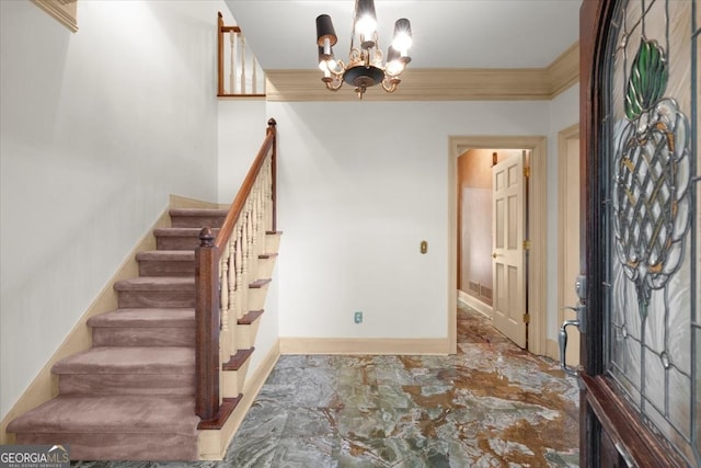 foyer entrance with a notable chandelier, stairs, baseboards, and crown molding