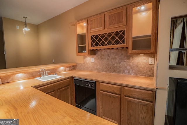 kitchen with light countertops, decorative backsplash, glass insert cabinets, a sink, and dishwasher