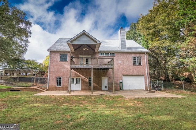 back of property featuring french doors, brick siding, a yard, and fence