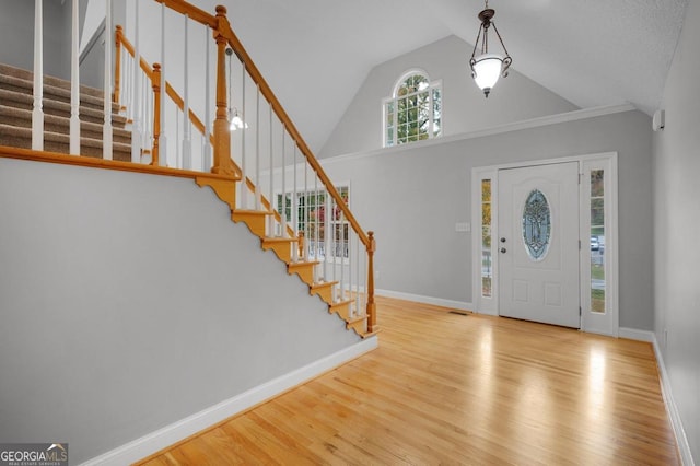 foyer entrance featuring light hardwood / wood-style floors and vaulted ceiling