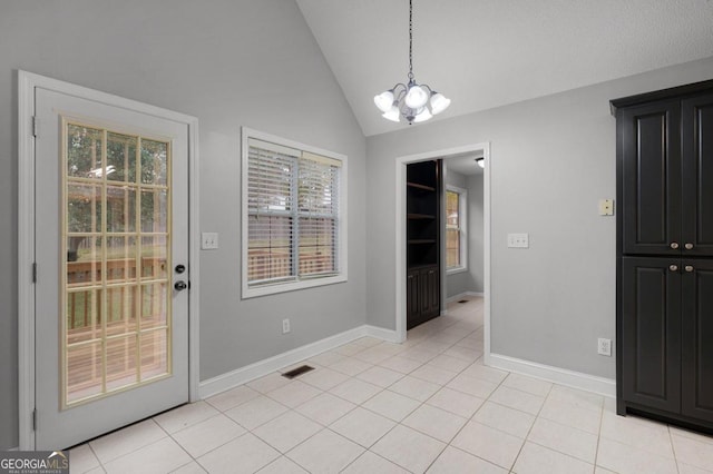 interior space featuring light tile patterned flooring, lofted ceiling, and an inviting chandelier