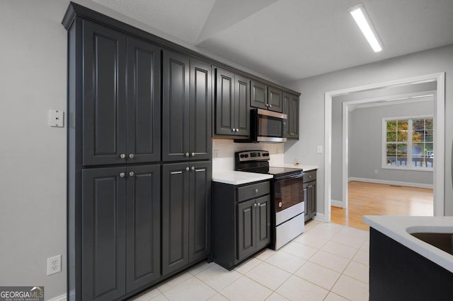 kitchen with light tile patterned floors and electric stove