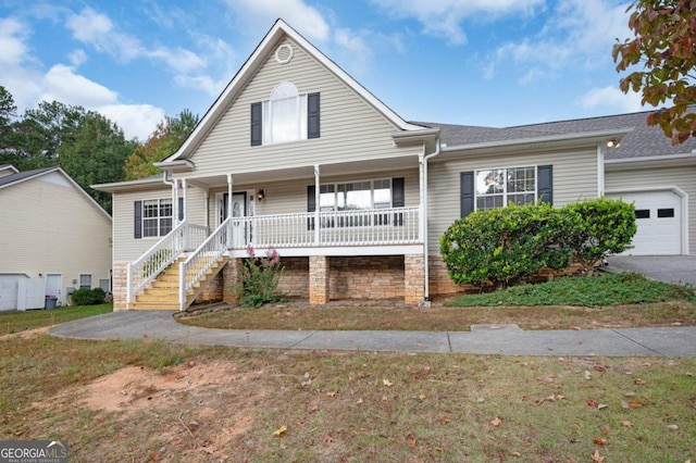 view of front property featuring covered porch and a garage