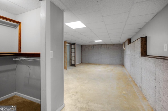 basement featuring a paneled ceiling