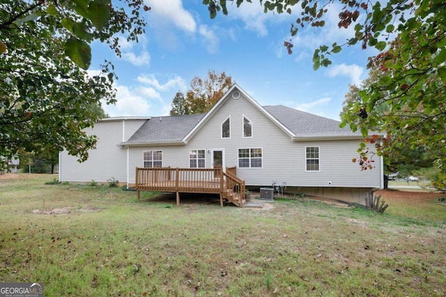 rear view of house with a wooden deck, central AC, and a yard