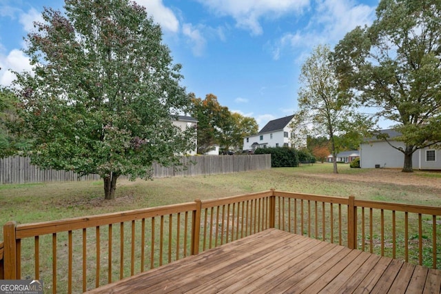 wooden terrace with a lawn