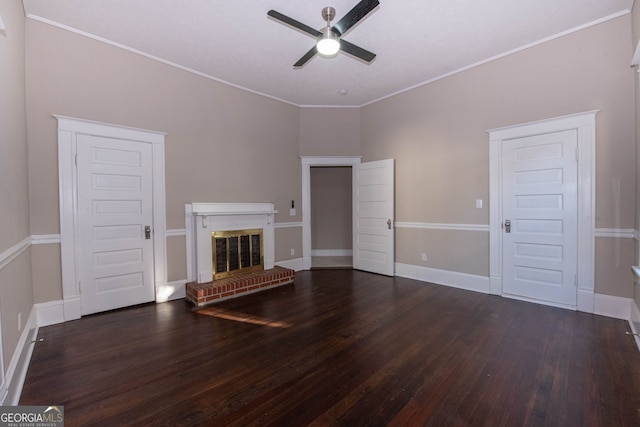 unfurnished living room featuring ornamental molding, dark wood-type flooring, a fireplace, and ceiling fan